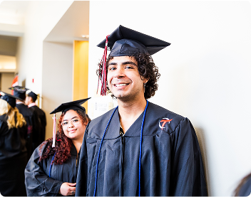 graduating student posing for a picture in their cap and gown
