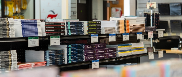 Shelves stocked with textbooks, notebooks, and school supplies at the OTECH college store, one of the campus services available to students and community members