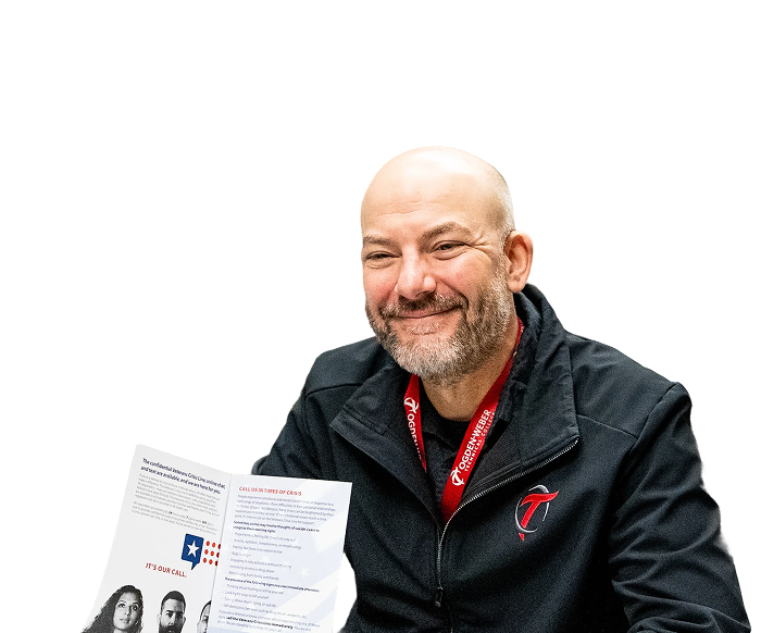 A smiling OTECH staff member wearing an OTECH lanyard holds a VA benefits brochure, representing the veterans benefits and financial aid resources available to eligible students at OTECH
