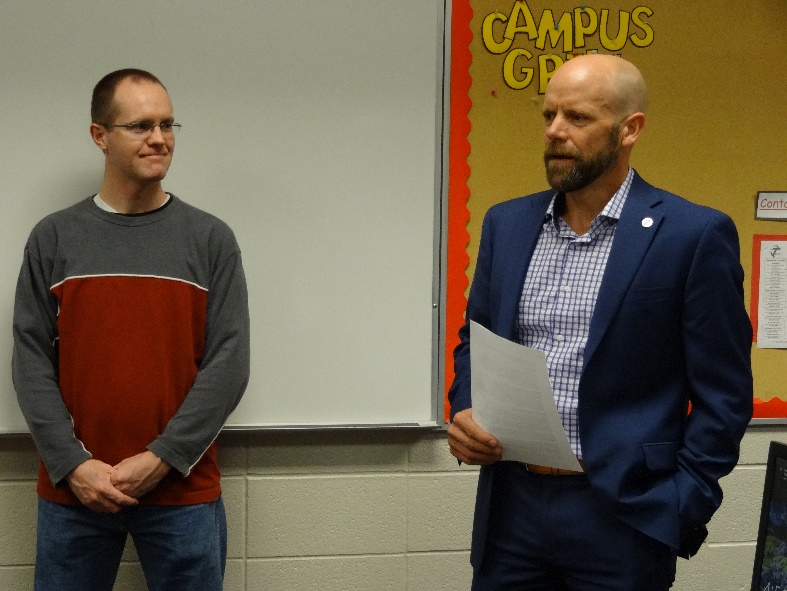  Brett Osmonson, award recipient, and Tyler Call, vice president for college services.